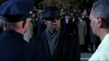 Movie still from “Malcolm X” (1992), directed by Spike Lee – A man wearing a hat and a scarf; Close Up shot, Over the shoulder angle