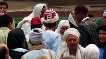 Movie still from “Malcolm X” (1992), directed by Spike Lee – A group of men in white turbans standing next to each other; Medium shot, High angle