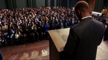 Movie still from “Malcolm X” (1992), directed by Spike Lee – A man is giving a speech in front of an audience; Extreme Wide shot, High angle