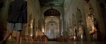 Movie still from “Malena” (2000), directed by Giuseppe Tornatore – An empty church with a lot of chairs in it; Extreme Wide shot, Low angle