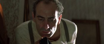 Movie still from “Malena” (2000), directed by Giuseppe Tornatore – An older man is looking down at his neck tie; Close Up shot, Low angle
