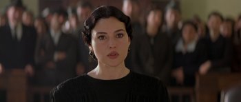 Movie still from “Malena” (2000), directed by Giuseppe Tornatore – A person wearing a black shirt; Close Up shot, Over the shoulder angle