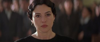 Movie still from “Malena” (2000), directed by Giuseppe Tornatore – A person wearing a black shirt; Close Up shot, Over the shoulder angle