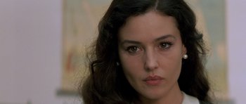Movie still from “Malena” (2000), directed by Giuseppe Tornatore – A woman's face with long dark hair; Close Up shot, Over the shoulder angle