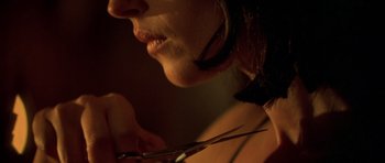Movie still from “Malena” (2000), directed by Giuseppe Tornatore – A person holding a pair of shears; Extreme Close Up shot, Over the shoulder angle
