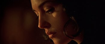 Movie still from “Malena” (2000), directed by Giuseppe Tornatore – A woman's face in the dark; Extreme Close Up shot, Low angle