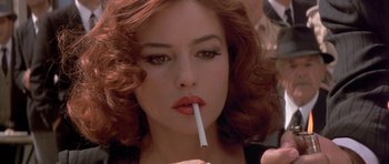 Movie still from “Malena” (2000), directed by Giuseppe Tornatore – A person holding a cigarette in her mouth; Close Up shot, Over the shoulder angle
