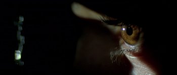 Movie still from “Malena” (2000), directed by Giuseppe Tornatore – A person's eye with a light shining on it; Extreme Close Up shot, High angle