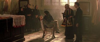 Movie still from “Malena” (2000), directed by Giuseppe Tornatore – A group of people standing in a room with smoke coming out of a window; Wide shot, High angle