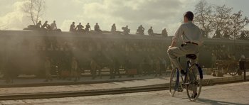 Movie still from “Malena” (2000), directed by Giuseppe Tornatore – A group of people standing next to a train on the tracks; Wide shot, Low angle