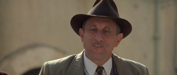 Movie still from “Malena” (2000), directed by Giuseppe Tornatore – An older man wearing a suit and a hat; Close Up shot, Low angle