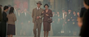 Movie still from “Malena” (2000), directed by Giuseppe Tornatore – A man and a woman walking in the fog; Wide shot, Low angle
