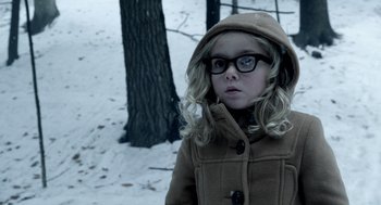 Movie still from “Mama” (2013), directed by Andy Muschietti – A little girl wearing a coat and glasses in the snow; Close Up shot, Over the shoulder angle