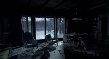 Movie still from “Mama” (2013), directed by Andy Muschietti – A room filled with chairs and a table in front of a large window; Extreme Wide shot, High angle