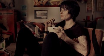 Movie still from “Mama” (2013), directed by Andy Muschietti – A woman sitting on a couch holding a wii controller; Medium shot, Over the shoulder angle
