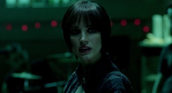 Movie still from “Mama” (2013), directed by Andy Muschietti – A person with short black hair; Close Up shot, Over the shoulder angle