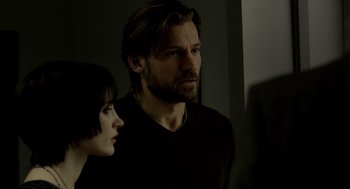 Movie still from “Mama” (2013), directed by Andy Muschietti – A man and a woman standing next to each other in a room; Close Up shot, Over the shoulder angle