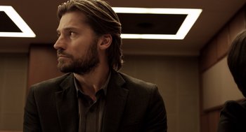 Movie still from “Mama” (2013), directed by Andy Muschietti – A man with a beard and a suit and tie; Close Up shot, Low angle
