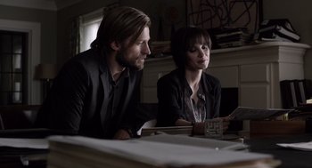 Movie still from “Mama” (2013), directed by Andy Muschietti – A man and a woman sitting at a dinner table; Medium shot, Over the shoulder angle