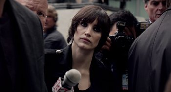 Movie still from “Mama” (2013), directed by Andy Muschietti – A woman is being interviewed by the press; Close Up shot, Over the shoulder angle