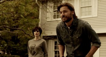 Movie still from “Mama” (2013), directed by Andy Muschietti – A man and a woman standing next to each other outside; Medium shot, Over the shoulder angle