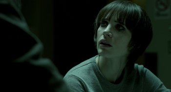 Movie still from “Mama” (2013), directed by Andy Muschietti – A woman looking at a cell phone in a dark room; Close Up shot, Over the shoulder angle