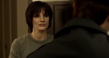 Movie still from “Mama” (2013), directed by Andy Muschietti – A person looking at a mirror; Close Up shot, Over the shoulder angle