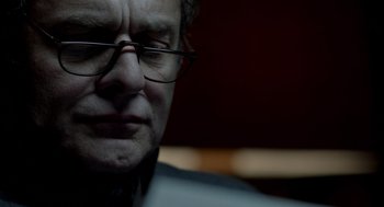 Movie still from “Mama” (2013), directed by Andy Muschietti – A person wearing glasses; Close Up shot, Low angle