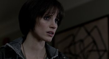 Movie still from “Mama” (2013), directed by Andy Muschietti – A person with short black hair; Close Up shot, Over the shoulder angle