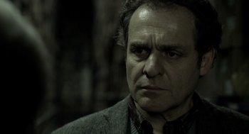 Movie still from “Mama” (2013), directed by Andy Muschietti – A person wearing a suit and tie; Close Up shot, Over the shoulder angle