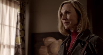 Movie still from “Mama” (2013), directed by Andy Muschietti – A person standing in a room; Close Up shot, Over the shoulder angle