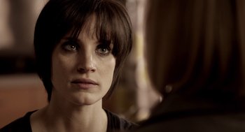 Movie still from “Mama” (2013), directed by Andy Muschietti – A person looking at the camera; Close Up shot, Over the shoulder angle