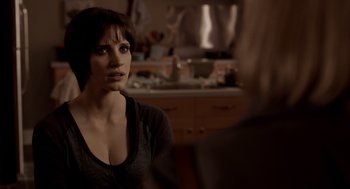 Movie still from “Mama” (2013), directed by Andy Muschietti – A woman sitting in front of a kitchen counter; Close Up shot, Over the shoulder angle