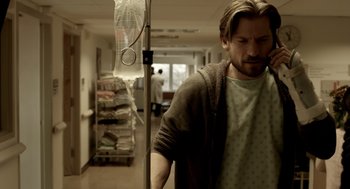 Movie still from “Mama” (2013), directed by Andy Muschietti – A man standing next to a hospital bed in a room; Medium shot, Over the shoulder angle