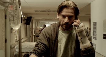 Movie still from “Mama” (2013), directed by Andy Muschietti – A man with long blonde hair talking on a phone; Close Up shot, Low angle