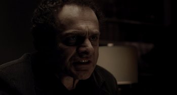 Movie still from “Mama” (2013), directed by Andy Muschietti – A person wearing a black shirt; Close Up shot, Low angle