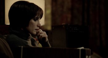 Movie still from “Mama” (2013), directed by Andy Muschietti – A woman sitting at a table looking at her cell phone; Close Up shot, Over the shoulder angle