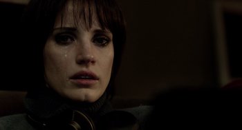 Movie still from “Mama” (2013), directed by Andy Muschietti – A person with a tear in her eye; Close Up shot, Over the shoulder angle