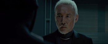 Movie still from “Man of Tai Chi” (2013), directed by Keanu Reeves – An older man with white hair looking into a mirror; Close Up shot, Over the shoulder angle