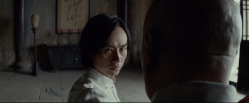 Movie still from “Man of Tai Chi” (2013), directed by Keanu Reeves – A man and a woman are looking at one another; Close Up shot, Over the shoulder angle