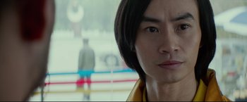 Movie still from “Man of Tai Chi” (2013), directed by Keanu Reeves – A person with long black hair; Close Up shot, Over the shoulder angle