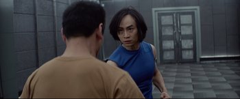 Movie still from “Man of Tai Chi” (2013), directed by Keanu Reeves – A man and a woman are facing each other; Medium shot, Over the shoulder angle
