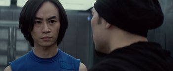 Movie still from “Man of Tai Chi” (2013), directed by Keanu Reeves – A man and a woman are talking to each other; Close Up shot, Over the shoulder angle