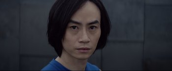 Movie still from “Man of Tai Chi” (2013), directed by Keanu Reeves – A person wearing a blue shirt; Close Up shot, Low angle