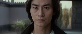 Movie still from “Man of Tai Chi” (2013), directed by Keanu Reeves – A person with long hair; Close Up shot, Low angle