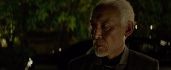 Movie still from “Man of Tai Chi” (2013), directed by Keanu Reeves – An older man with white hair looking at the camera; Close Up shot, Over the shoulder angle