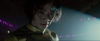 Movie still from “Man of Tai Chi” (2013), directed by Keanu Reeves – A man with long hair is looking at the camera; Close Up shot, Low angle