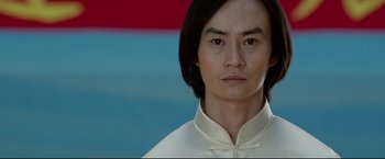 Movie still from “Man of Tai Chi” (2013), directed by Keanu Reeves – A person wearing a white shirt; Close Up shot, Low angle