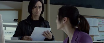 Movie still from “Man of Tai Chi” (2013), directed by Keanu Reeves – A man and a woman looking at each other in a mirror; Close Up shot, Over the shoulder angle