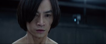 Movie still from “Man of Tai Chi” (2013), directed by Keanu Reeves – A person with long black hair; Close Up shot, Over the shoulder angle